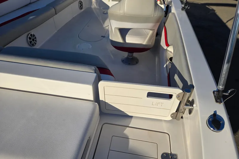 Slide: The Image of 2019 Starcraft MDX 211 O/B boat interior with seating and storage compartments. - 24