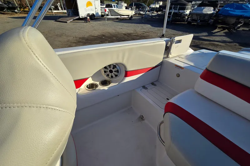 Slide: The Image of 2019 Starcraft MDX 211 O/B boat interior with red and white seating, cup holders, and speaker. - 28
