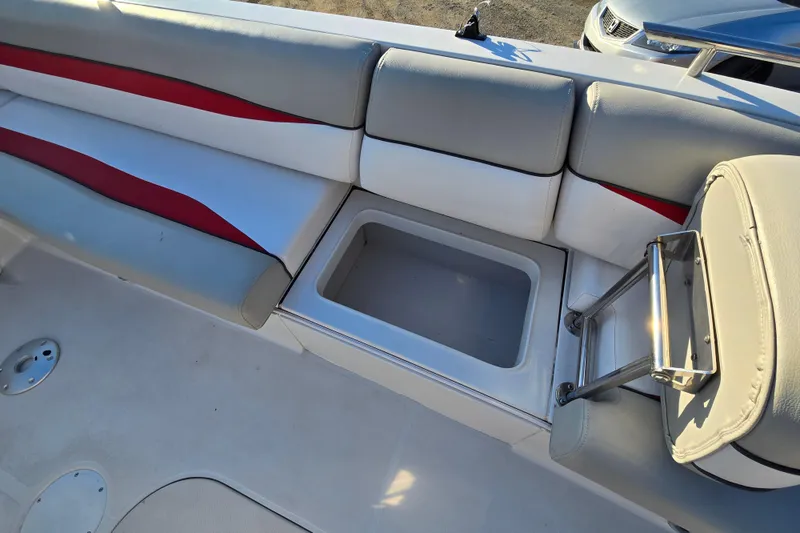 Slide: The Image of 2019 Starcraft MDX 211 O/B boat interior with cushioned seating and storage compartment. - 30