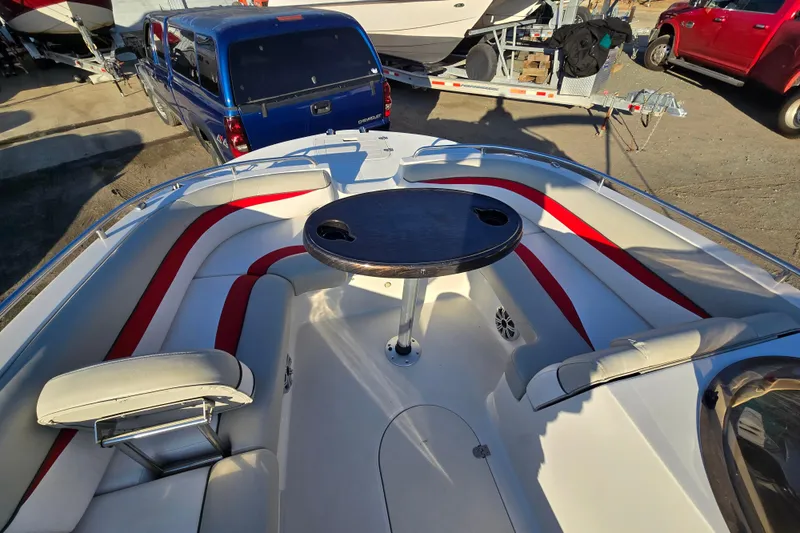 Slide: The Image of 2019 Starcraft MDX 211 O/B boat interior with red and white seating and a central table. - 31