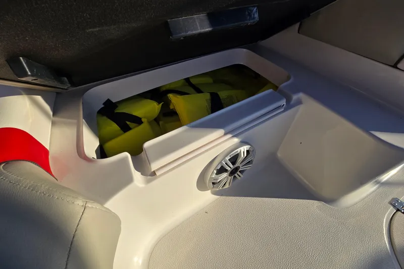 Slide: The Image of 2019 Starcraft MDX 211 O/B boat storage with life jackets and speaker. - 33