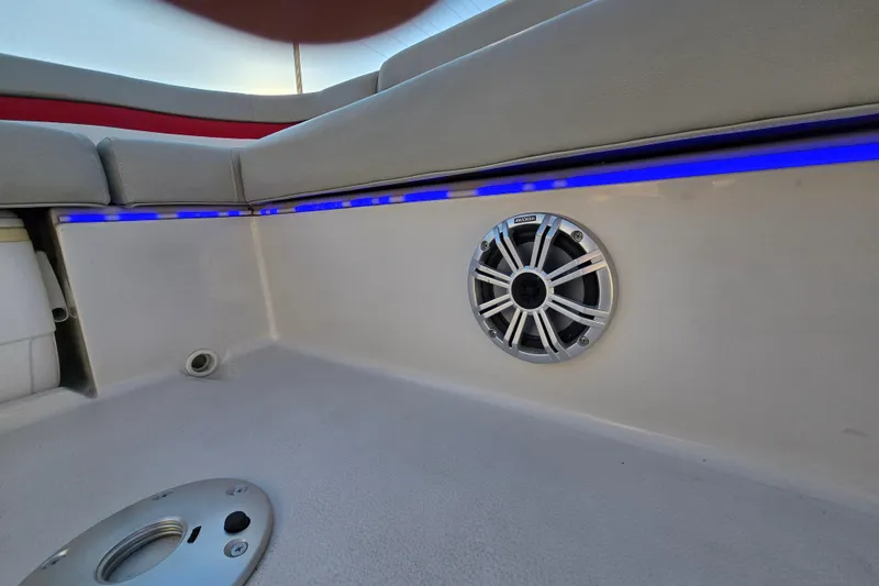 Slide: The Image of 2019 Starcraft MDX 211 O/B boat interior with blue LED lighting and speaker. - 34