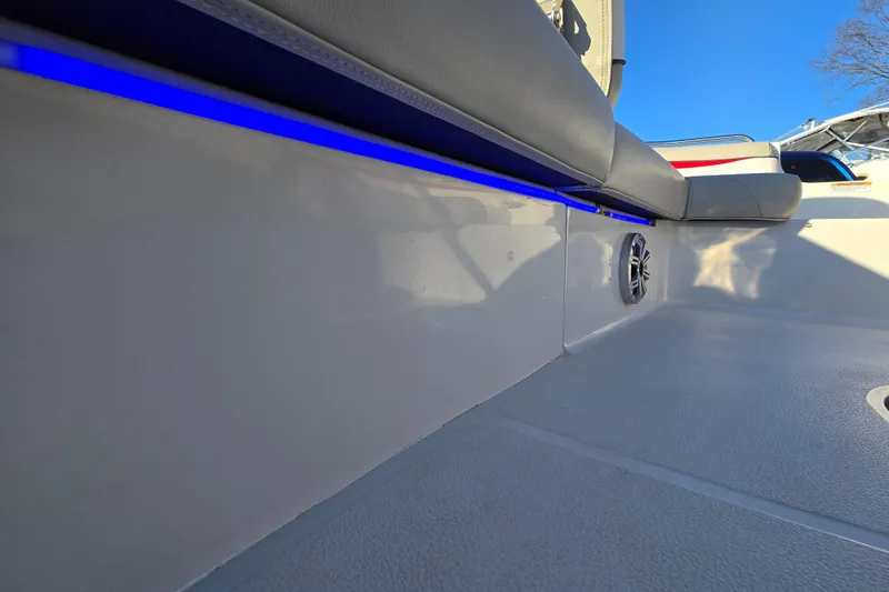 Slide: The Image of 2019 Starcraft MDX 211 O/B boat interior with blue LED lighting and speaker. - 35