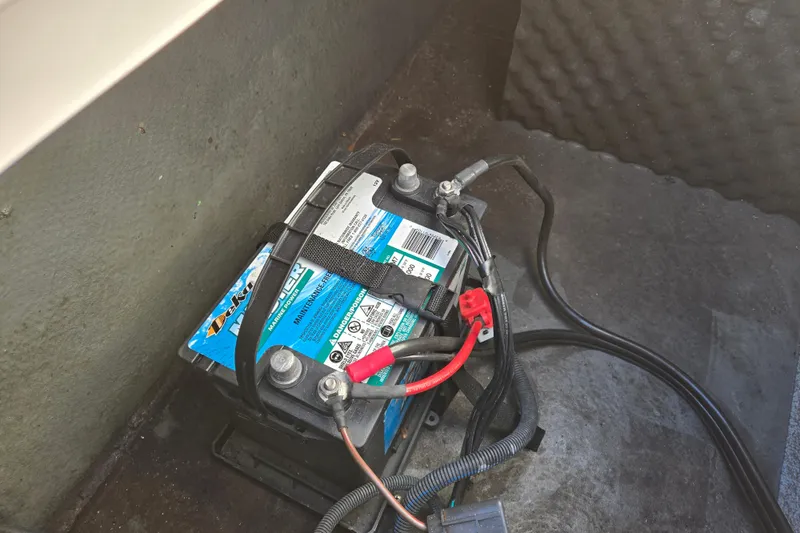 Slide: The Image of Battery compartment of 2019 Starcraft MDX 211 O/B boat, featuring wiring and secure straps. - 37