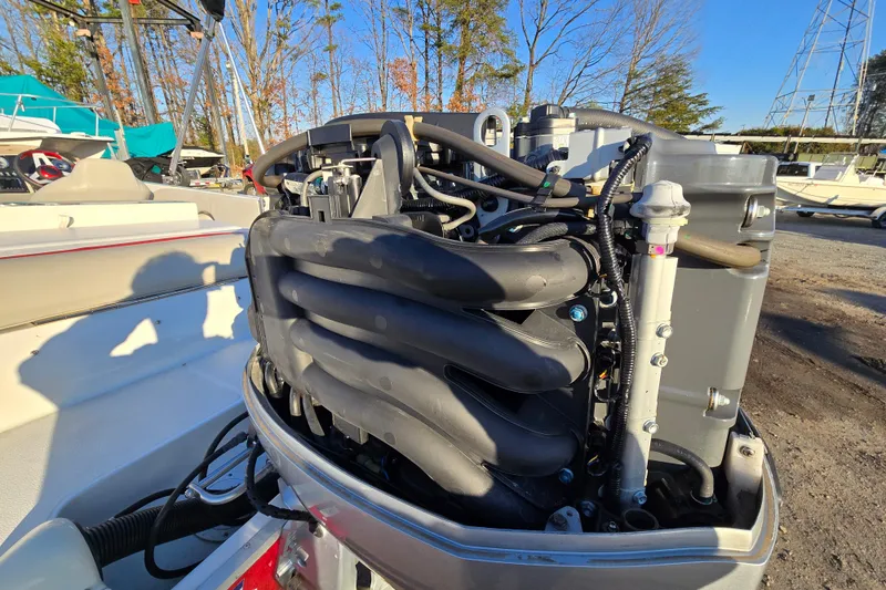 Slide: The Image of 2019 Starcraft MDX 211 O/B boat engine, detailed view in a marina setting. - 39