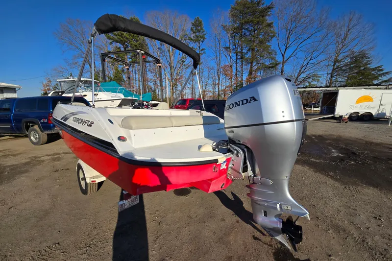 Slide: The Image of 2019 Starcraft MDX 211 O/B boat with Honda outboard motor, parked outdoors. - 7