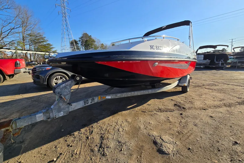 Slide: The Image of 2019 Starcraft MDX 211 O/B boat on trailer, parked outdoors under clear sky. - 8