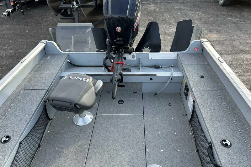 Slide: The Image of 2025 Lund 2075 Alaskan Tiller boat interior with motor and seating. - 5