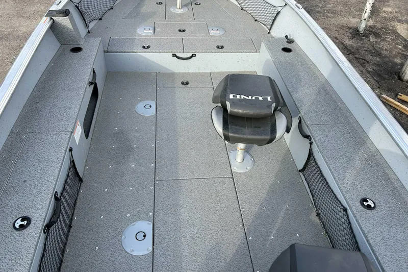 Slide: The Image of 2025 Lund 2075 Alaskan Tiller boat interior with seating and storage compartments. - 6