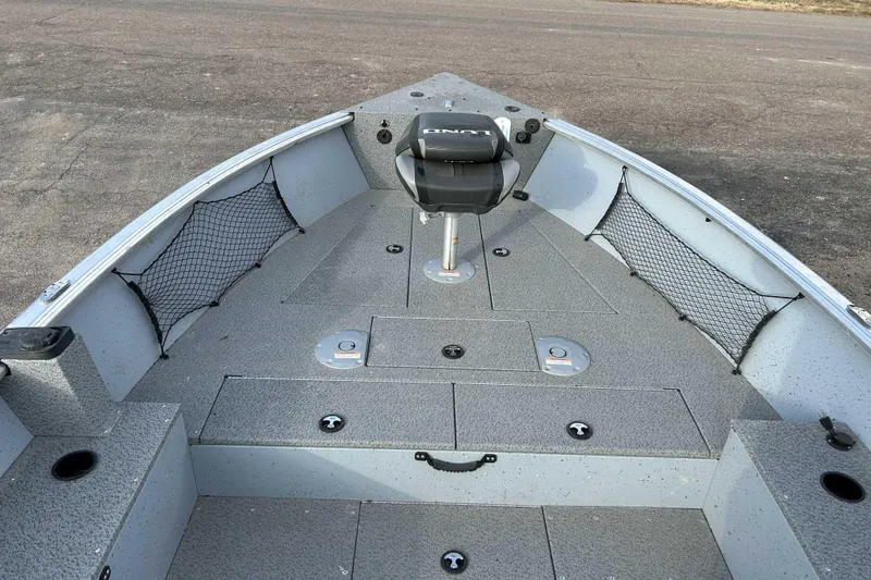 Slide: The Image of 2025 Lund 2075 Alaskan Tiller boat interior with seating and storage compartments. - 7