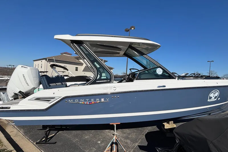 The Image of 2026 Monterey Elite 27 OB boat with sleek design, parked outdoors under clear blue sky. - 0