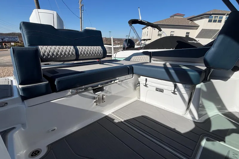 Slide: The Image of 2026 Monterey Elite 27 OB boat interior with cushioned seating and Yeti cooler. - 13