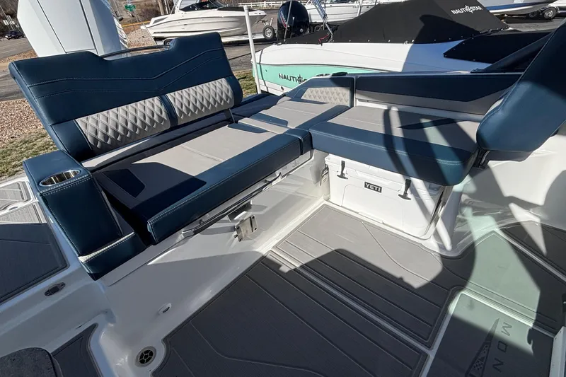 Slide: The Image of Luxury seating on 2026 Monterey Elite 27 OB boat with integrated cooler. - 14