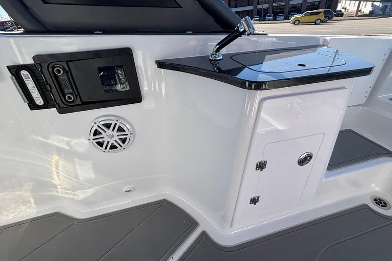 Slide: The Image of 2026 Monterey Elite 27 OB boat interior with sleek sink and storage cabinet. - 18