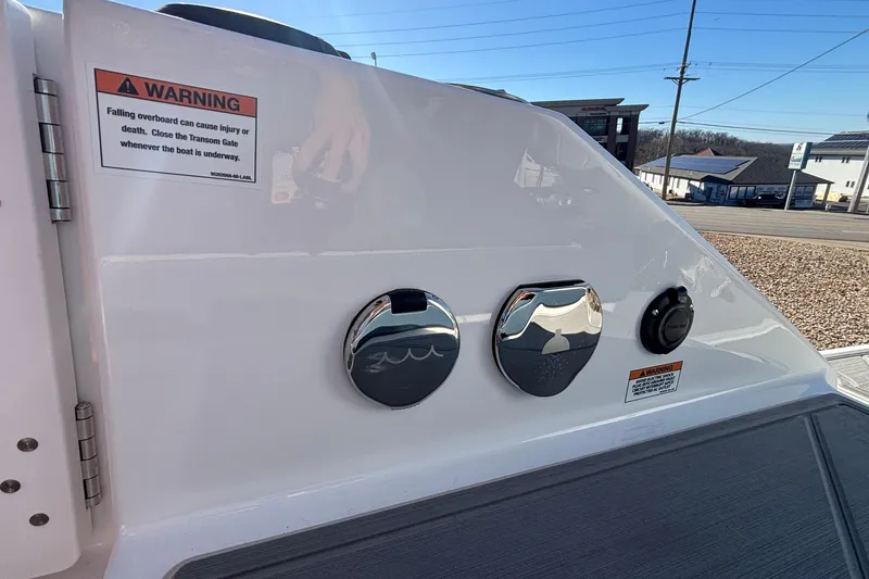 Slide: The Image of 2026 Monterey Elite 27 OB boat dashboard with warning labels and controls. - 20