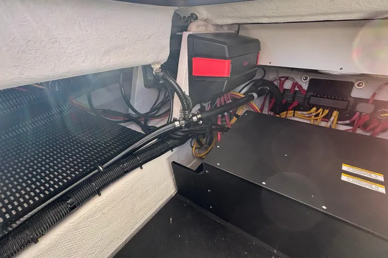 Slide: The Image of Engine compartment of 2026 Monterey Elite 27 OB boat, showcasing wiring and components. - 25