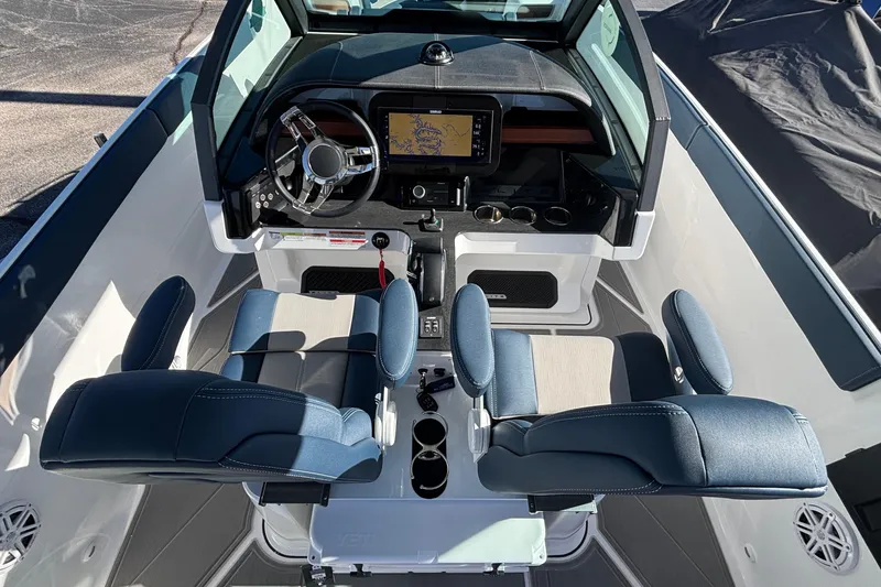 Slide: The Image of 2026 Monterey Elite 27 OB boat interior with modern dashboard and blue seating. - 28