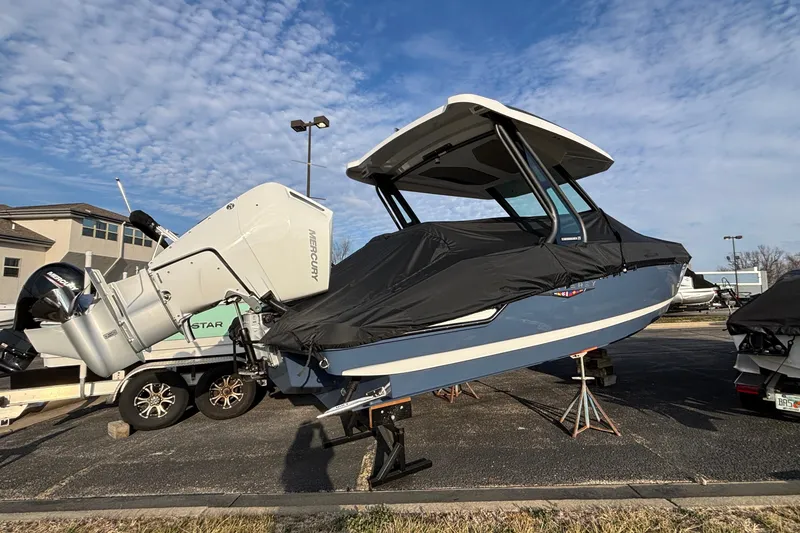 Slide: The Image of 2026 Monterey Elite 27 OB boat with Mercury outboard engine, covered and parked outdoors. - 3