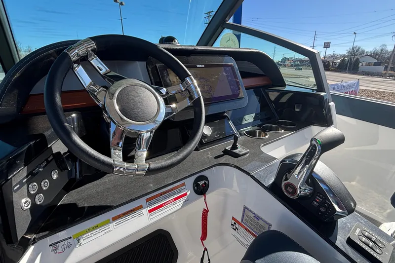 Slide: The Image of Cockpit of 2026 Monterey Elite 27 OB boat with modern steering and controls. - 30