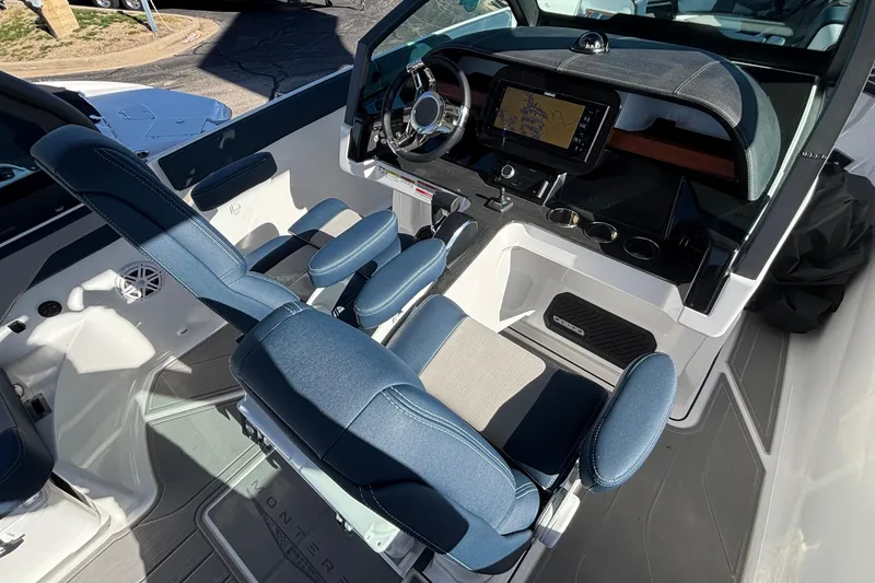 Slide: The Image of 2026 Monterey Elite 27 OB boat interior with modern dashboard and blue seating. - 31