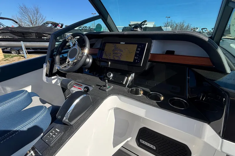 Slide: The Image of 2026 Monterey Elite 27 OB boat dashboard with steering wheel and navigation display. - 32