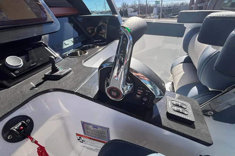 Slide: The Image of Control panel of 2026 Monterey Elite 27 OB boat with modern throttle and seating. - 33