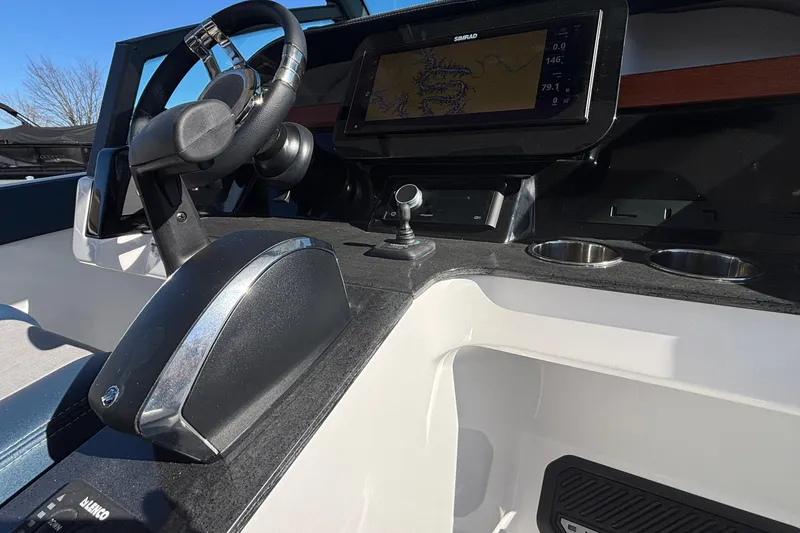 Slide: The Image of Cockpit of 2026 Monterey Elite 27 OB boat with steering wheel and navigation display. - 34