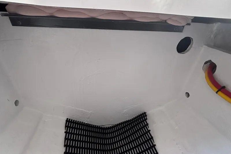 Slide: The Image of Interior view of 2026 Monterey Elite 27 OB boat, showcasing storage compartment details. - 39