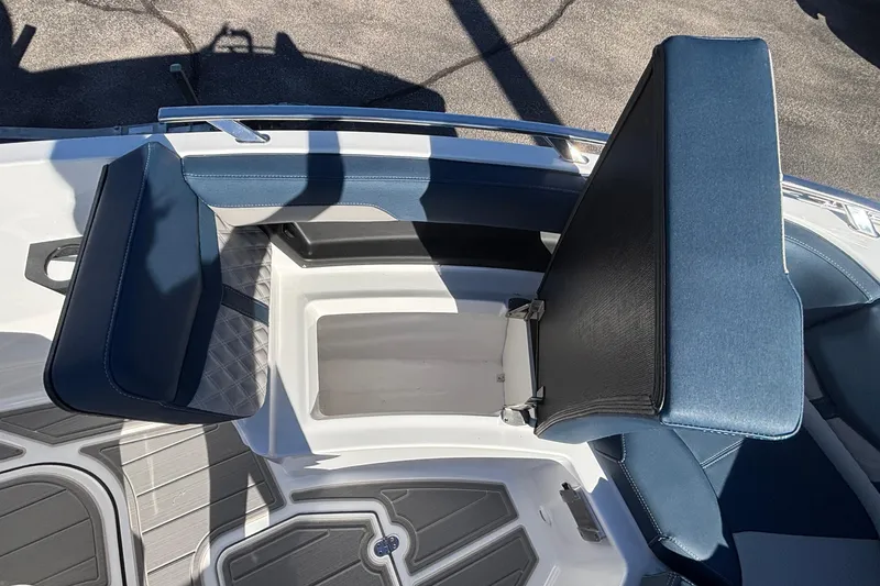 Slide: The Image of 2026 Monterey Elite 27 OB boat interior with blue seating and storage compartment. - 41