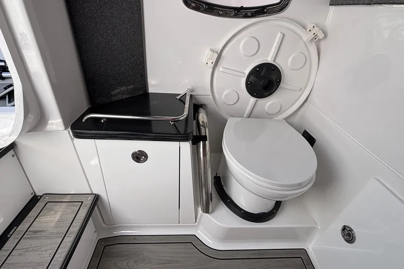 Slide: The Image of 2026 Monterey Elite 27 OB boat interior with modern toilet and sleek cabinetry. - 48