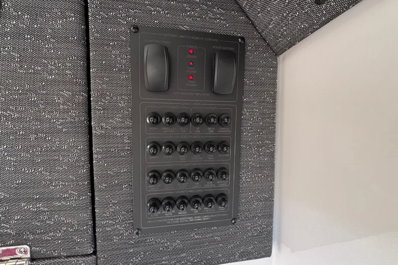 Slide: The Image of Control panel on 2026 Monterey Elite 27 OB boat, featuring switches and indicators. - 52