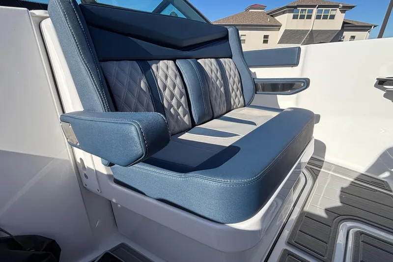 Slide: The Image of Luxurious seating on 2026 Monterey Elite 27 OB boat, featuring blue and gray upholstery. - 58