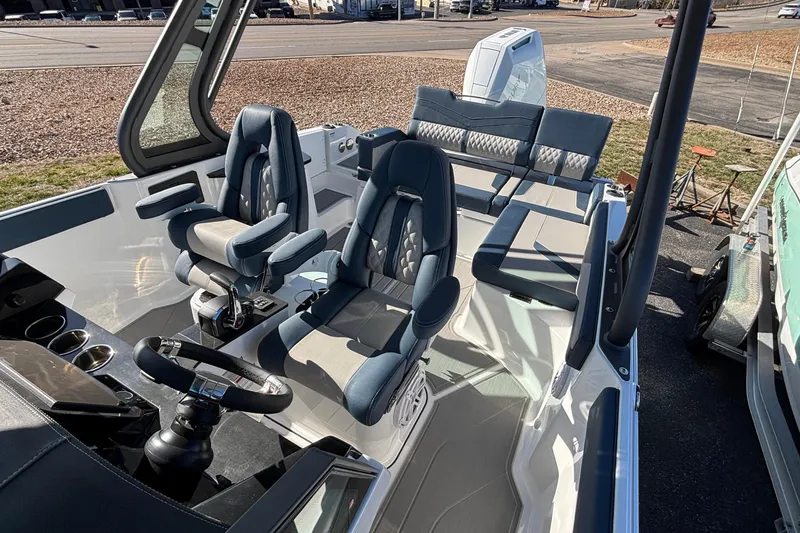 Slide: The Image of 2026 Monterey Elite 27 OB boat interior with modern seating and steering console. - 59