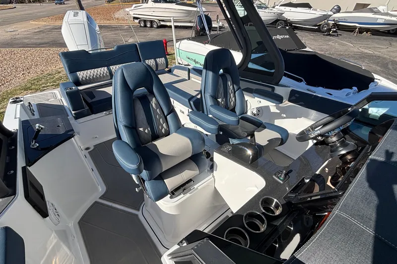 Slide: The Image of 2026 Monterey Elite 27 OB boat interior with luxurious seating and modern dashboard. - 61