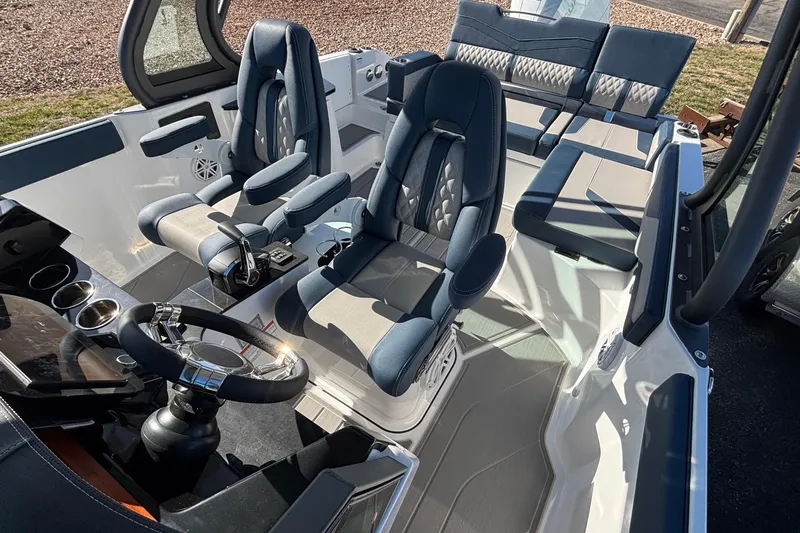 Slide: The Image of 2026 Monterey Elite 27 OB boat interior with modern seating and steering wheel. - 63
