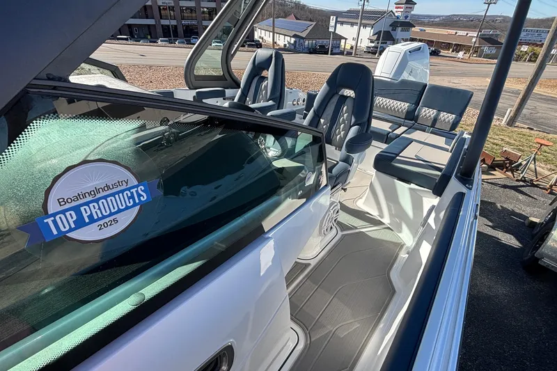 Slide: The Image of 2026 Monterey Elite 27 OB boat interior with award sticker, showcasing luxury seating and design. - 64