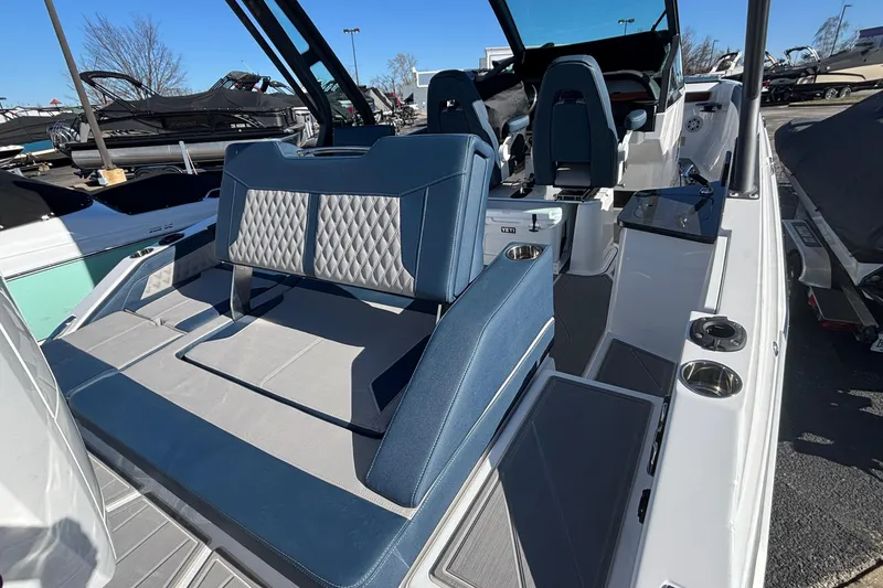 Slide: The Image of 2026 Monterey Elite 27 OB boat interior with blue and gray seating, cup holders, and modern design. - 7