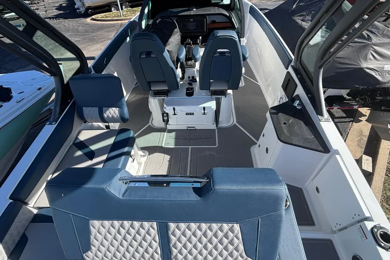Slide: The Image of 2026 Monterey Elite 27 OB boat interior with blue seating and modern dashboard. - 8
