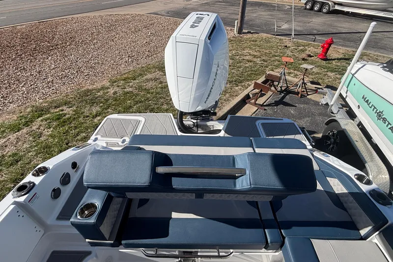 Slide: The Image of 2026 Monterey Elite 27 OB boat with blue seating and powerful outboard motor. - 9