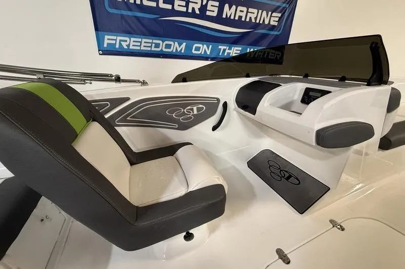 Slide: The Image of 2024 Tahoe T21 boat interior with modern seating and dashboard, displayed at Miller's Marine. - 10