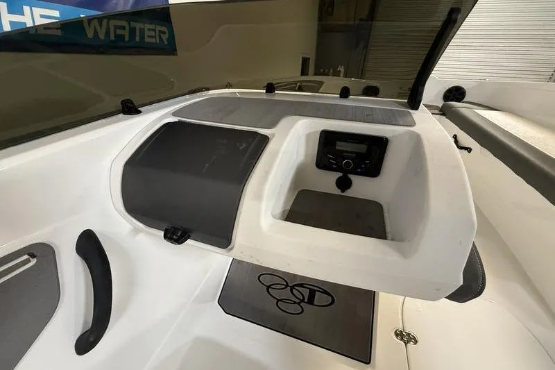 Slide: The Image of 2024 Tahoe T21 boat dashboard with control panel and storage compartment. - 12