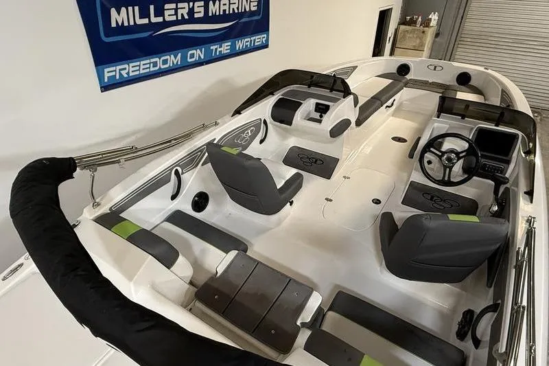 Slide: The Image of 2024 Tahoe T21 boat interior with seating and steering, displayed at Miller's Marine showroom. - 14