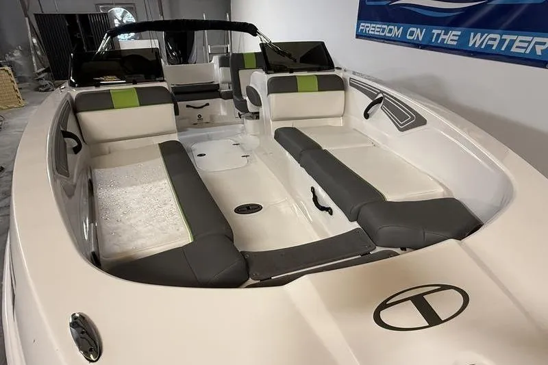 Slide: The Image of 2024 Tahoe T21 boat interior with gray and green seating, showcasing spacious design. - 16