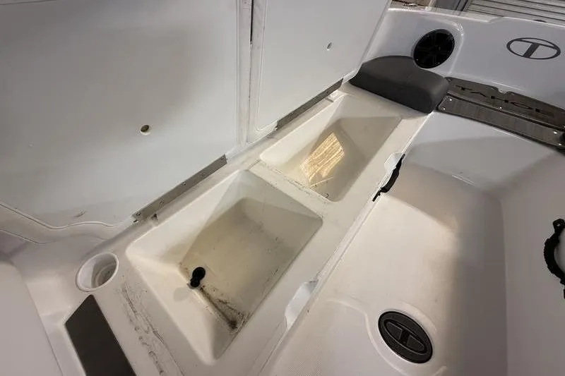 Slide: The Image of 2024 Tahoe T21 boat interior storage compartments and seating area. - 18