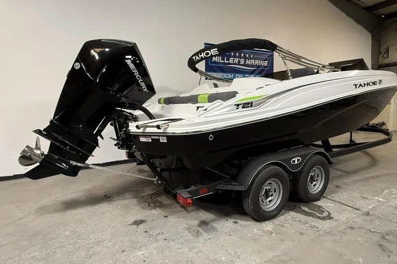Slide: The Image of 2024 Tahoe T21 boat on trailer with Mercury outboard motor in showroom. - 3