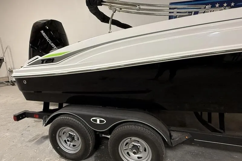 Slide: The Image of 2024 Tahoe T21 boat on trailer, featuring sleek black and white design. - 4