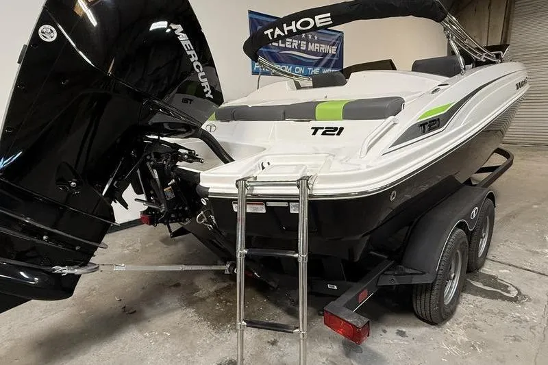 Slide: The Image of 2024 Tahoe T21 boat on trailer with Mercury engine, displayed indoors. - 5