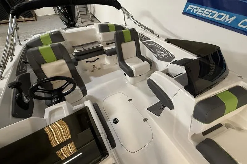 Slide: The Image of 2024 Tahoe T21 boat interior with modern seating and steering wheel. - 7