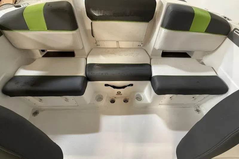 Slide: The Image of 2024 Tahoe T21 boat interior with black and green cushioned seating. - 8