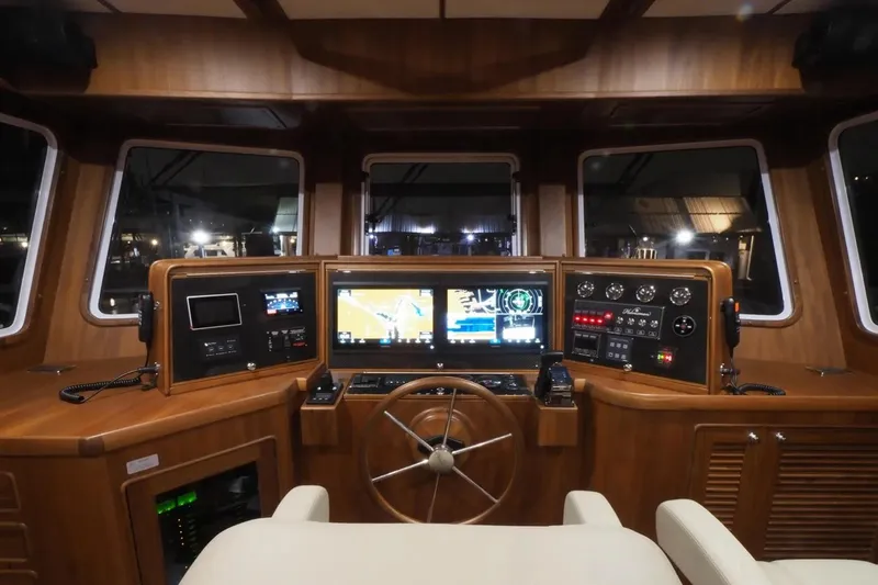 The Image of Helmsman Trawlers 46 Pilothouse 2025 interior with advanced navigation controls and wooden finish. - 0